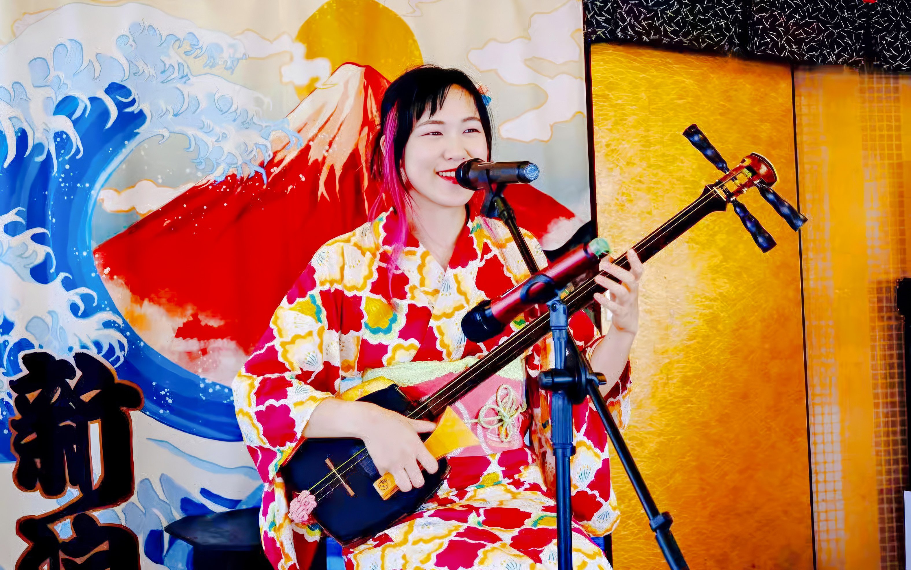 Singer playing shamisen on Traditional Yakatabune Cruise with Mount Fuji backdrop.