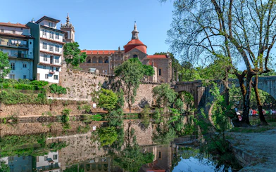 Douro Historical Tour: scenic view of Porto's architecture and river reflection.
