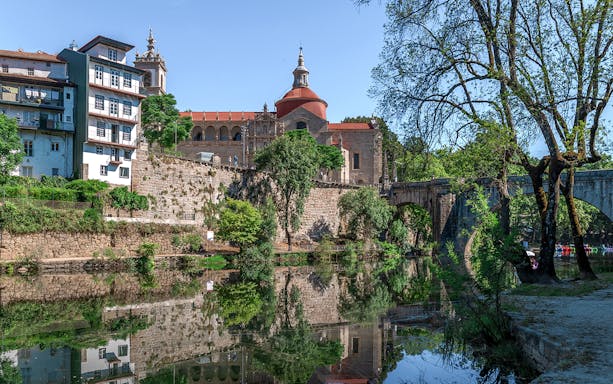 Douro Historical Tour: scenic view of Porto's architecture and river reflection.
