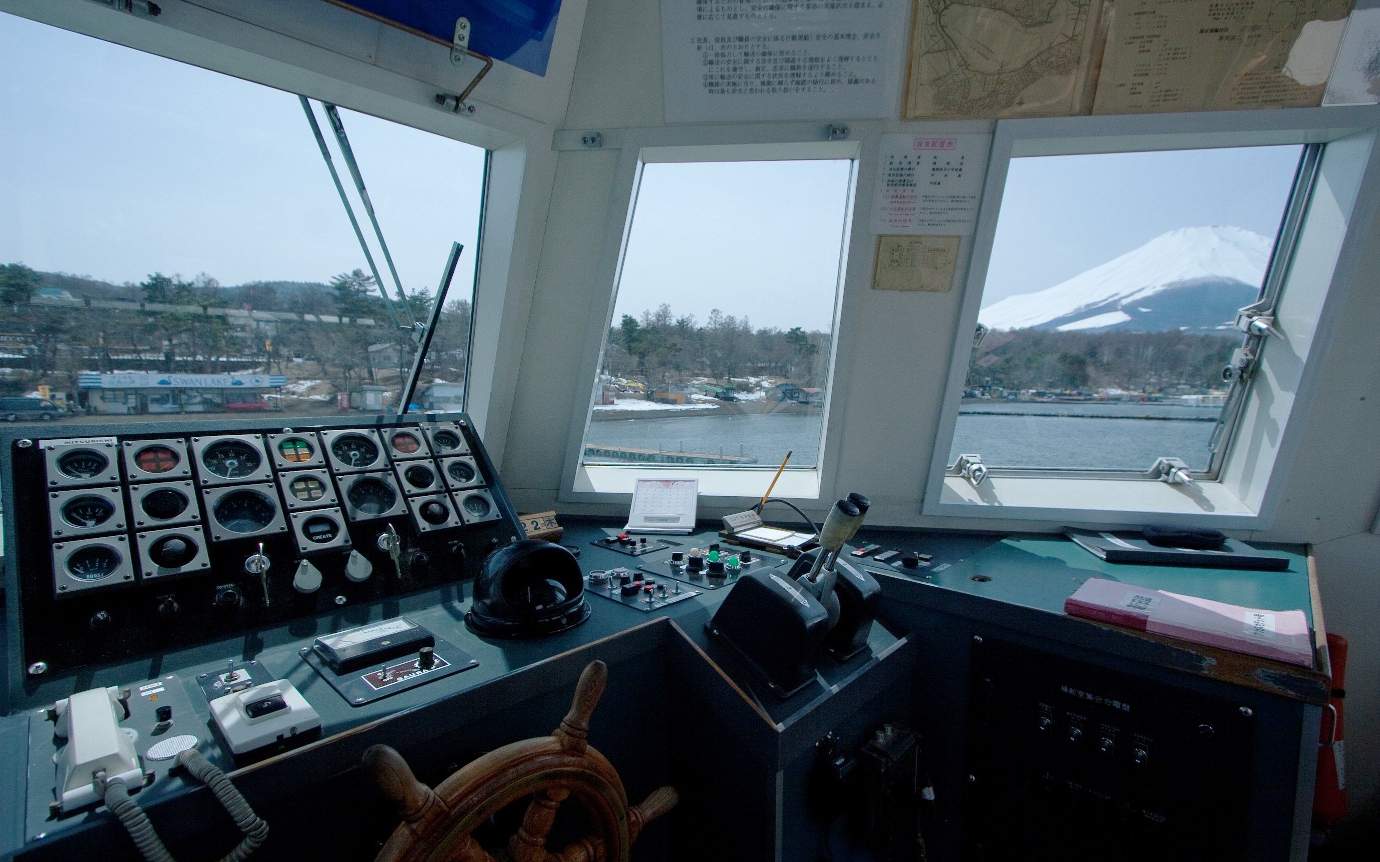 Boat cockpit view of Lake Yamanaka with Mount Fuji in the background.