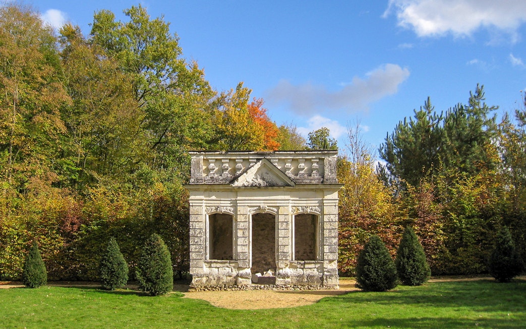 Trianon structure surrounded by trees at Château de Chenonceau, Loire Valley.