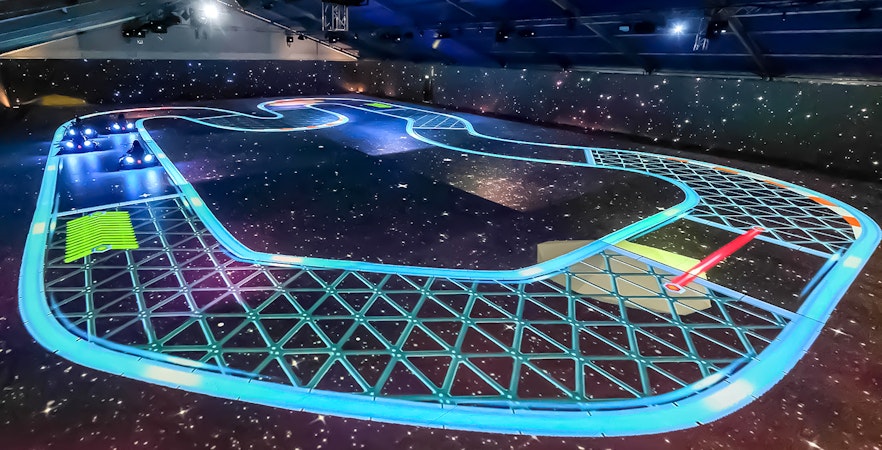 Racers on a lit up track at Chaos Karts Dubai