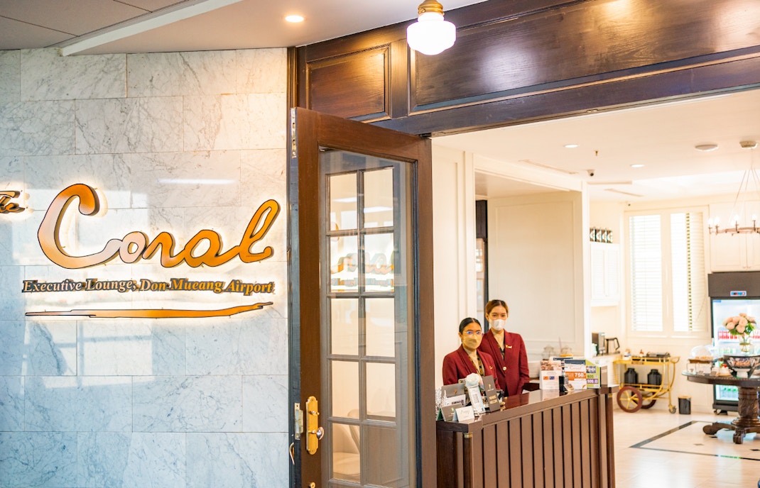 Entrance to The Coral Executive Lounge at Bangkok Airport, Thailand, with staff at reception.