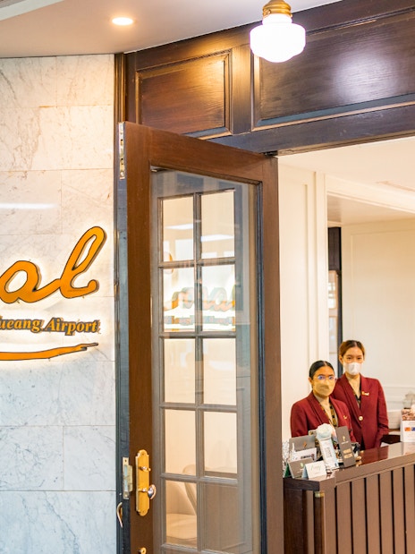 Entrance to The Coral Executive Lounge at Bangkok Airport, Thailand, with staff at reception.