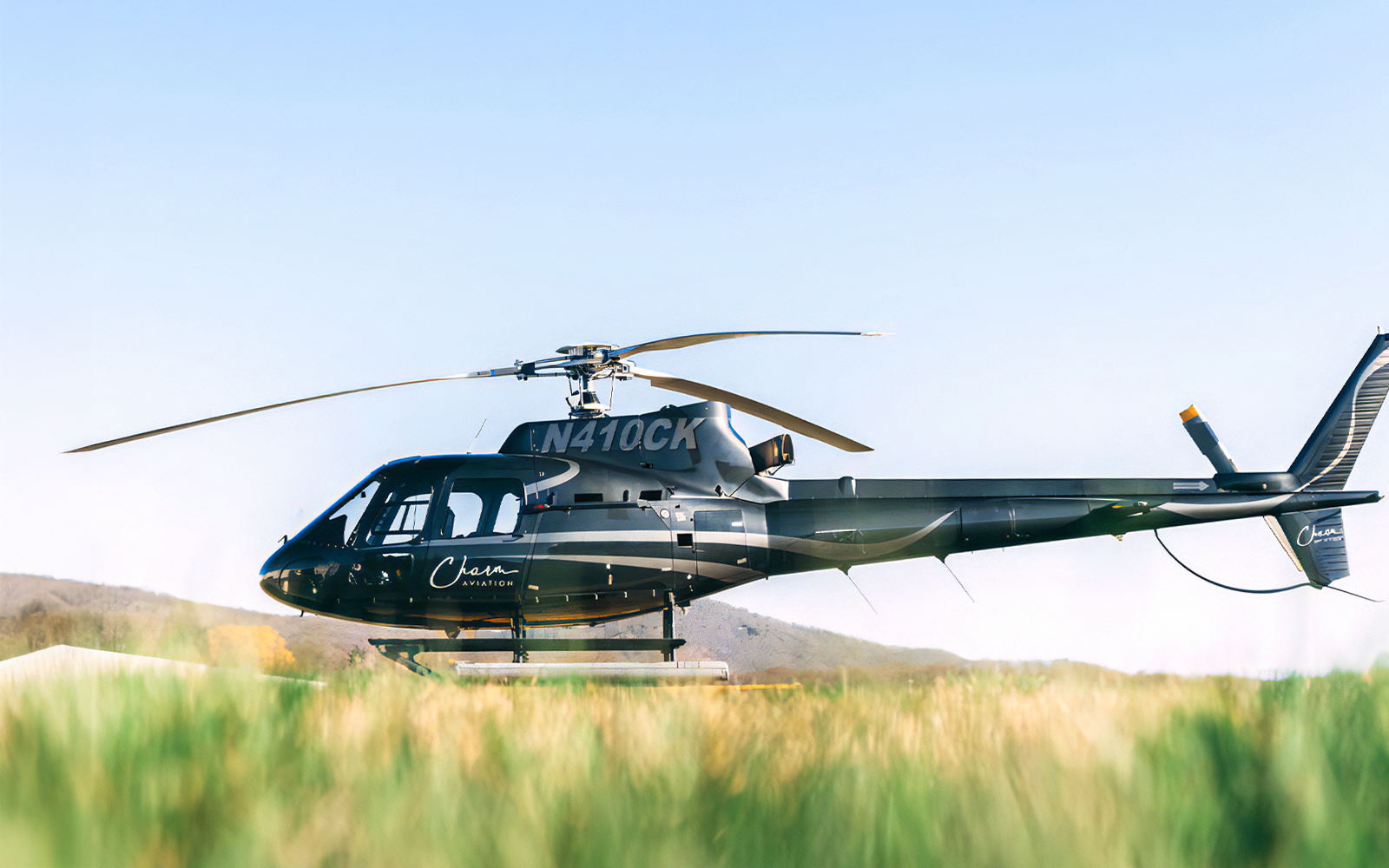 Helicopter on grass field for NYC tour from New Jersey.