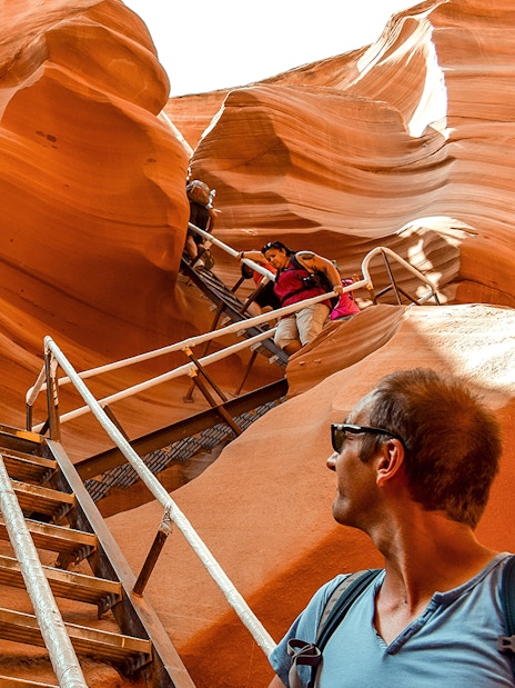 Tourists climbing stairs in Lower Antelope Canyon, Arizona, during a day tour from Las Vegas.
