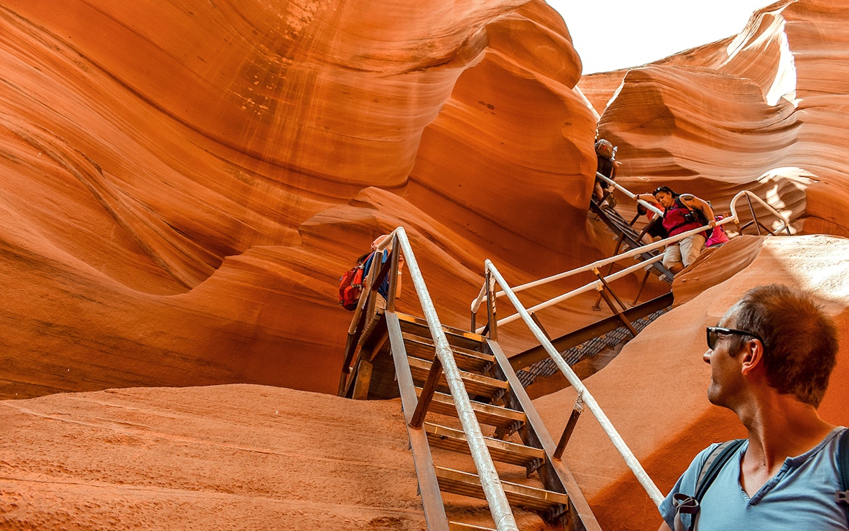 Tourists climbing stairs in Lower Antelope Canyon, Arizona, during a day tour from Las Vegas.