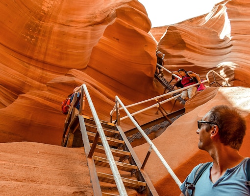 Tourists climbing stairs in Lower Antelope Canyon, Arizona, during a day tour from Las Vegas.
