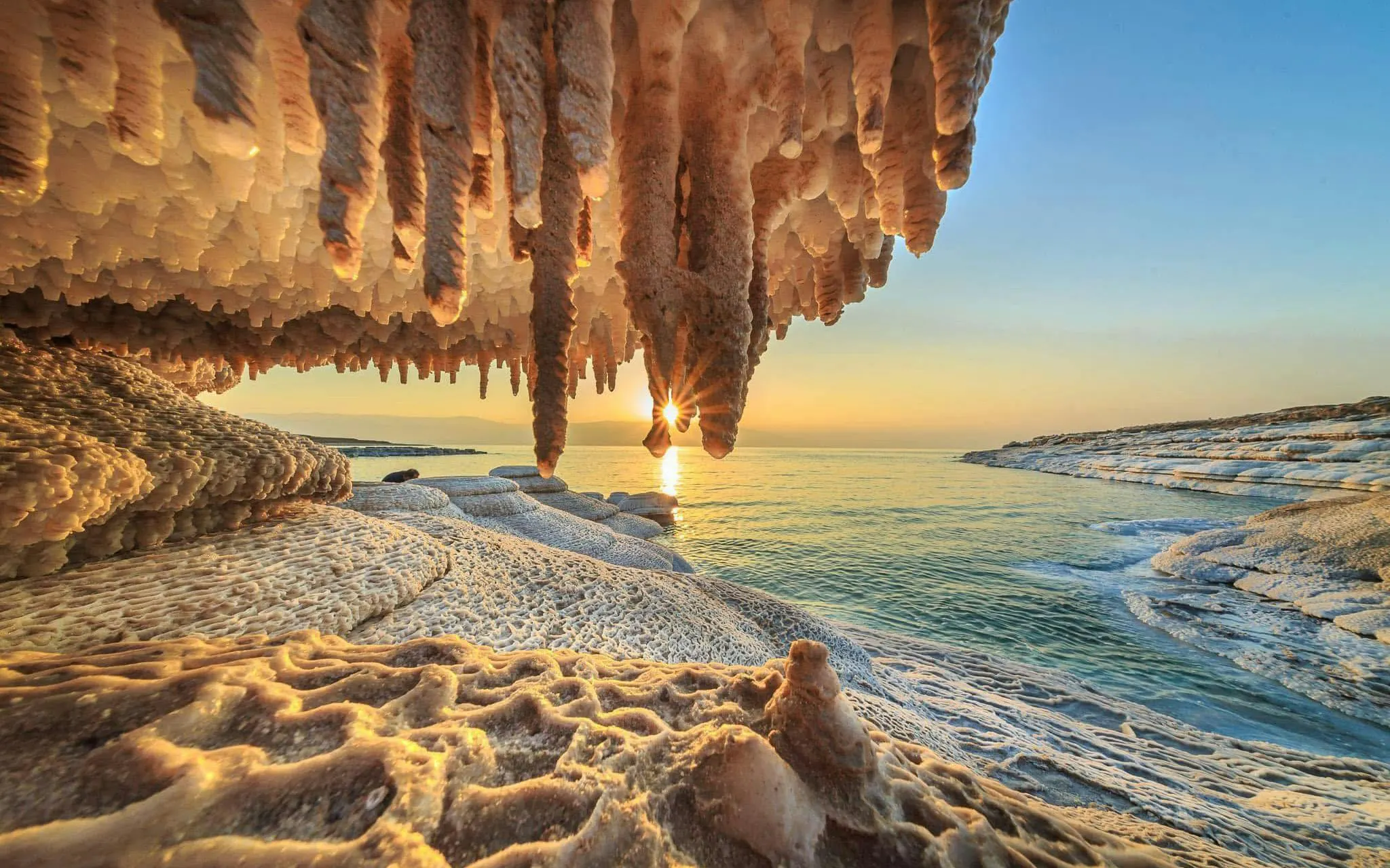 Salt formations at sunrise on the Dead Sea shoreline during a tour from Amman.