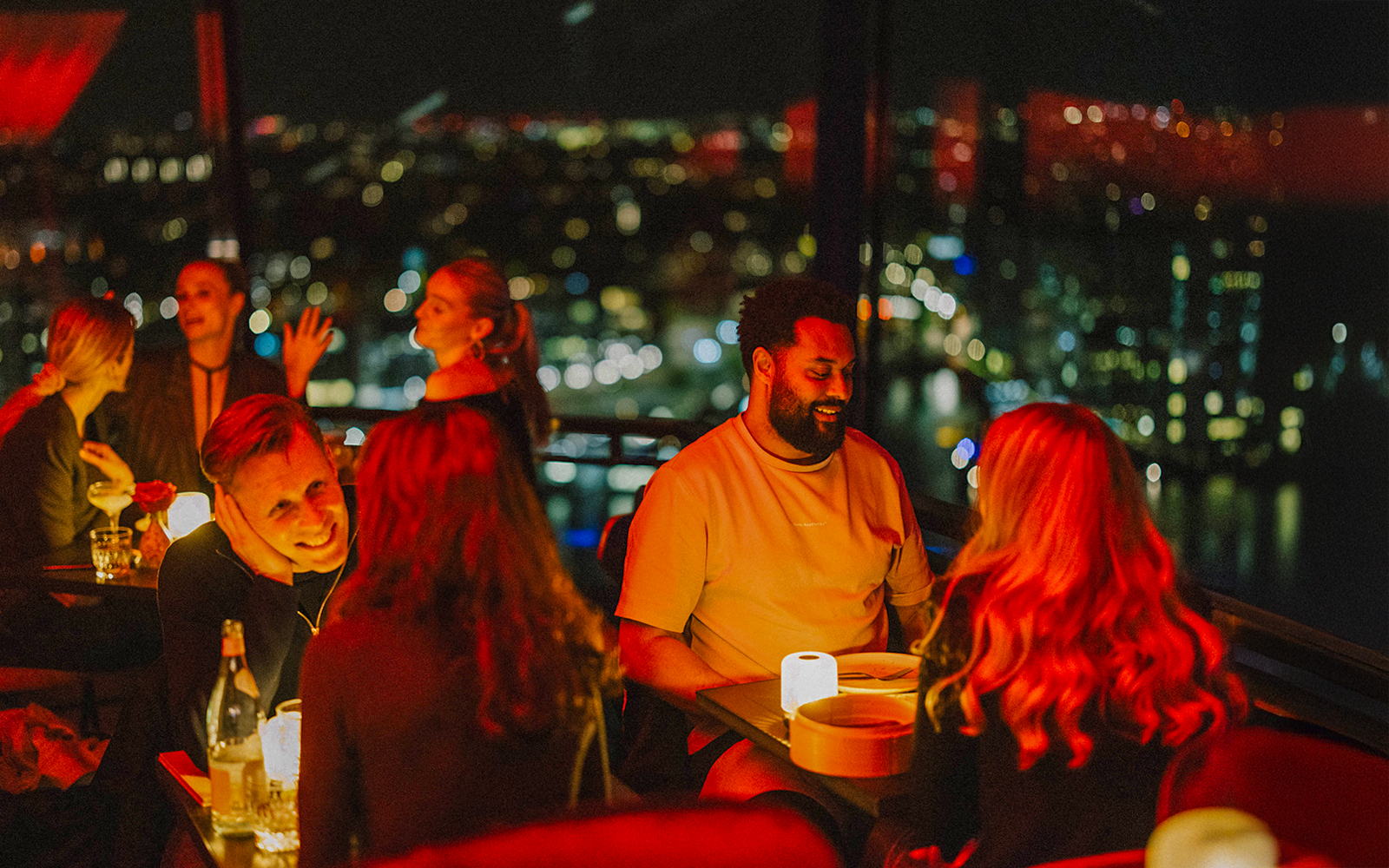 Dinner at Madam Skybar Restaurant with city skyline view at night.