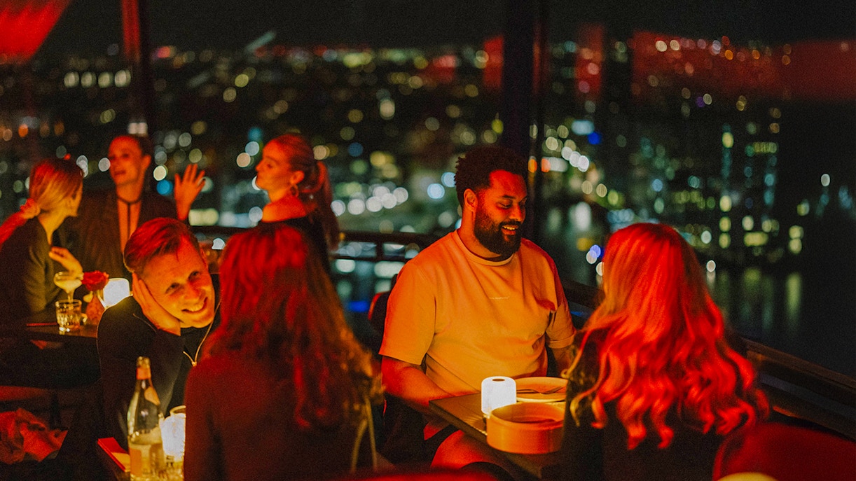 Dinner at Madam Skybar Restaurant with city skyline view at night.