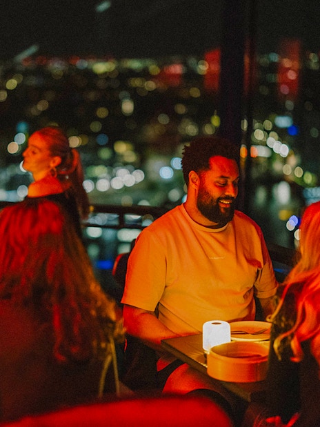 Dinner at Madam Skybar Restaurant with city skyline view at night.