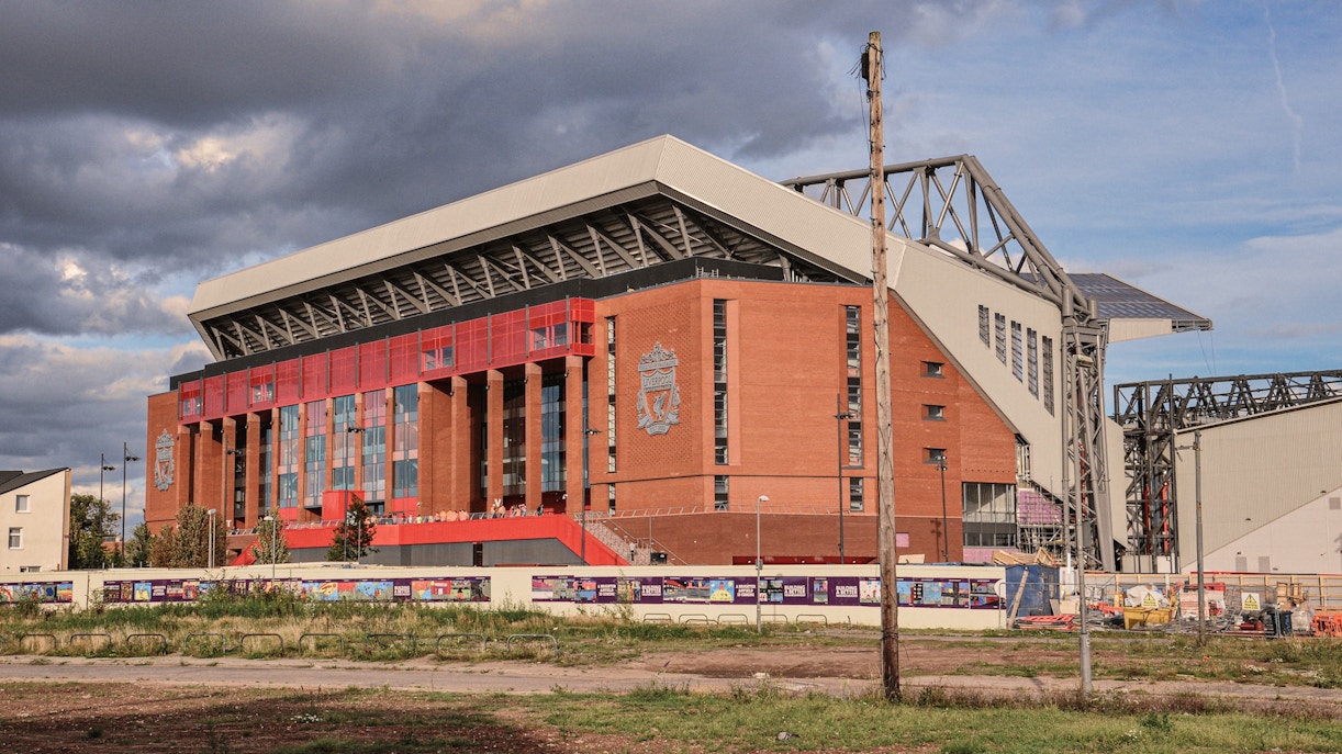Liverpool FC Stadium exterior with iconic red signage and entrance in Liverpool, England.