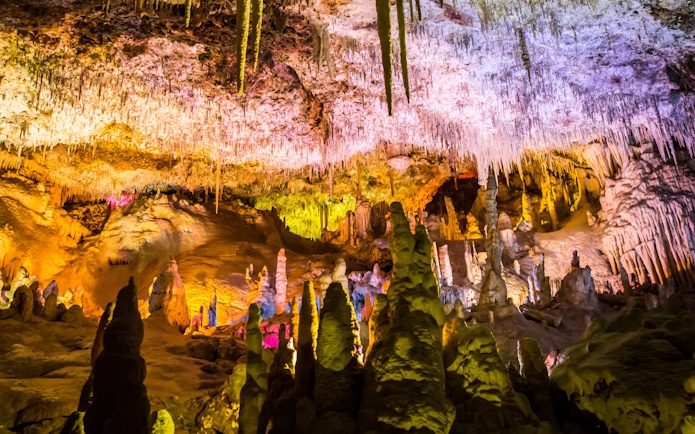 Stalactites and stalagmites in illuminated Drach Caves, Mallorca.