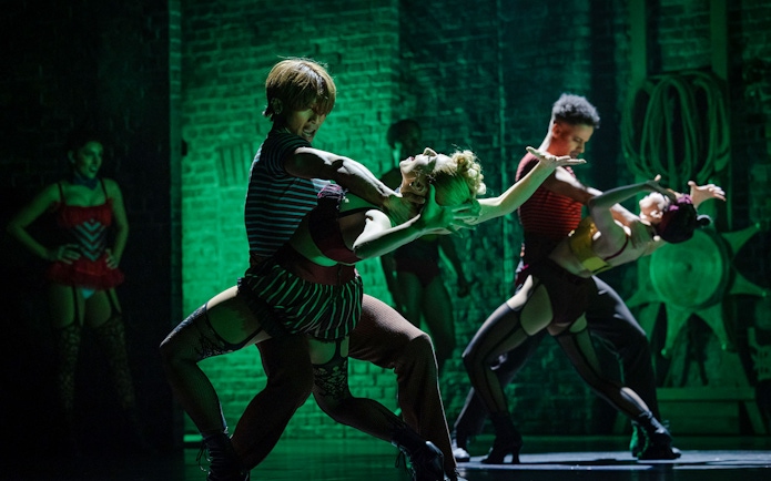 Performers dancing energetically in Moulin Rouge! The Musical, West End stage.