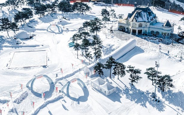 Aerial view of Vivaldi Park Ski Resort with snow-covered slopes and buildings.
