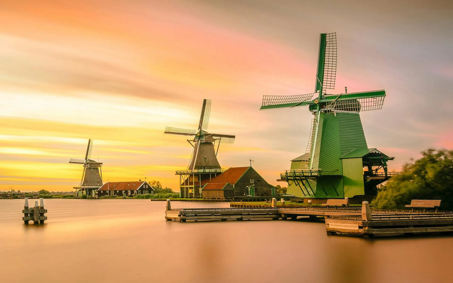 Windmills at sunset in Zaanse Schans, Netherlands.