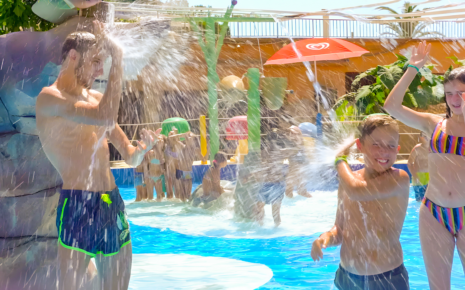 Family enjoying water play at Marineland Mallorca pool house.