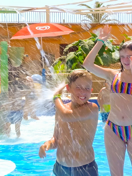 Family enjoying water play at Marineland Mallorca pool house.
