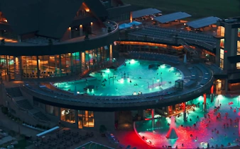 Thermal baths illuminated at night in Zakopane, part of a day trip from Krakow.