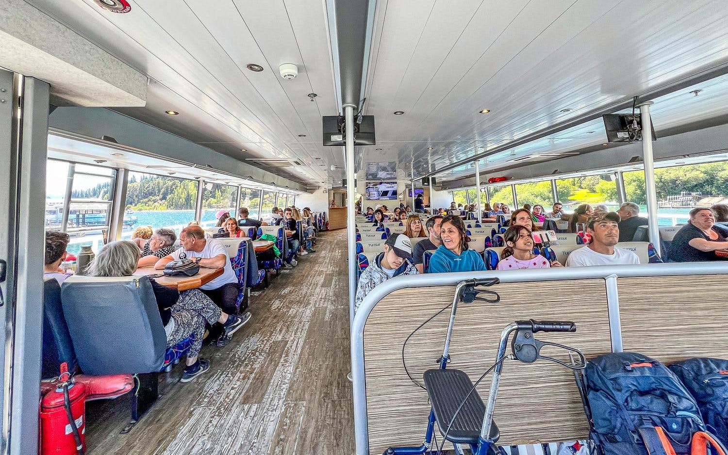 Sightseeing boat interior with passengers on Nahuel Huapi Lake, Argentina.