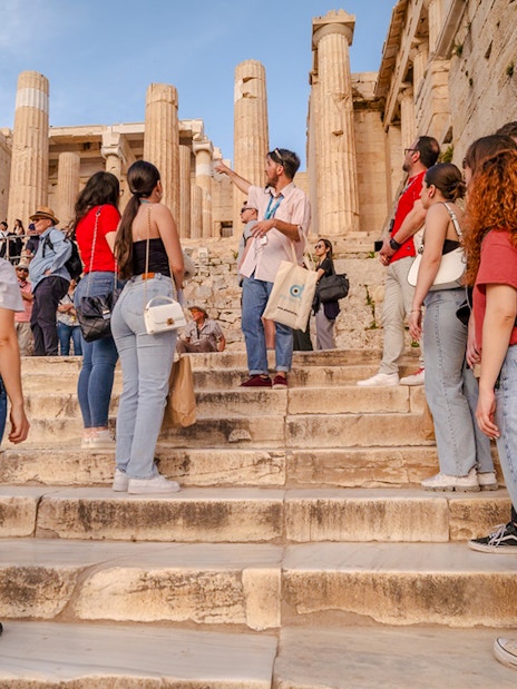 Tour group exploring the Parthenon with a guide in Athens, Greece.