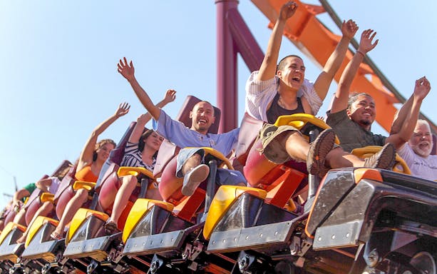 Roller coaster riders with raised arms at Six Flags Great America.