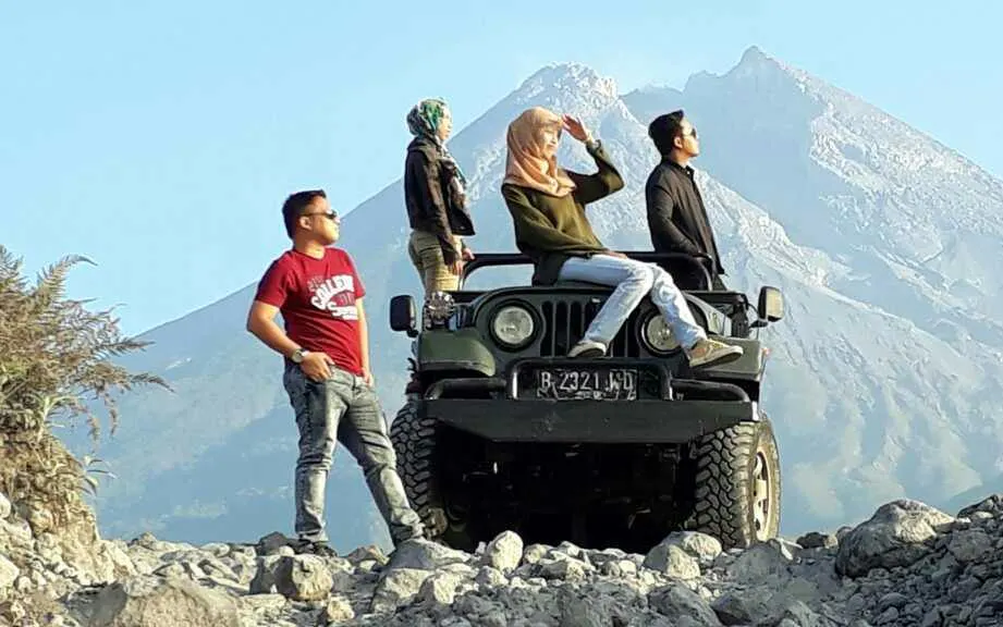 Group on Jeep during Merapi Lava Tour with mountain backdrop, Dubai.