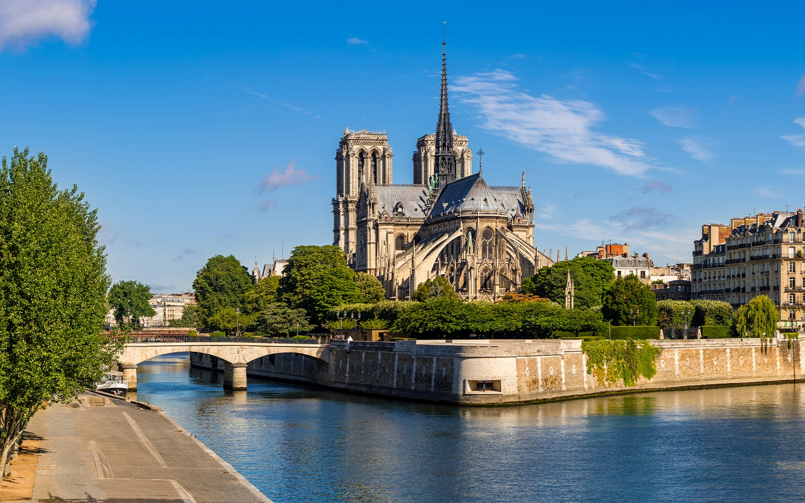 Notre Dame during golden hour with a river view.