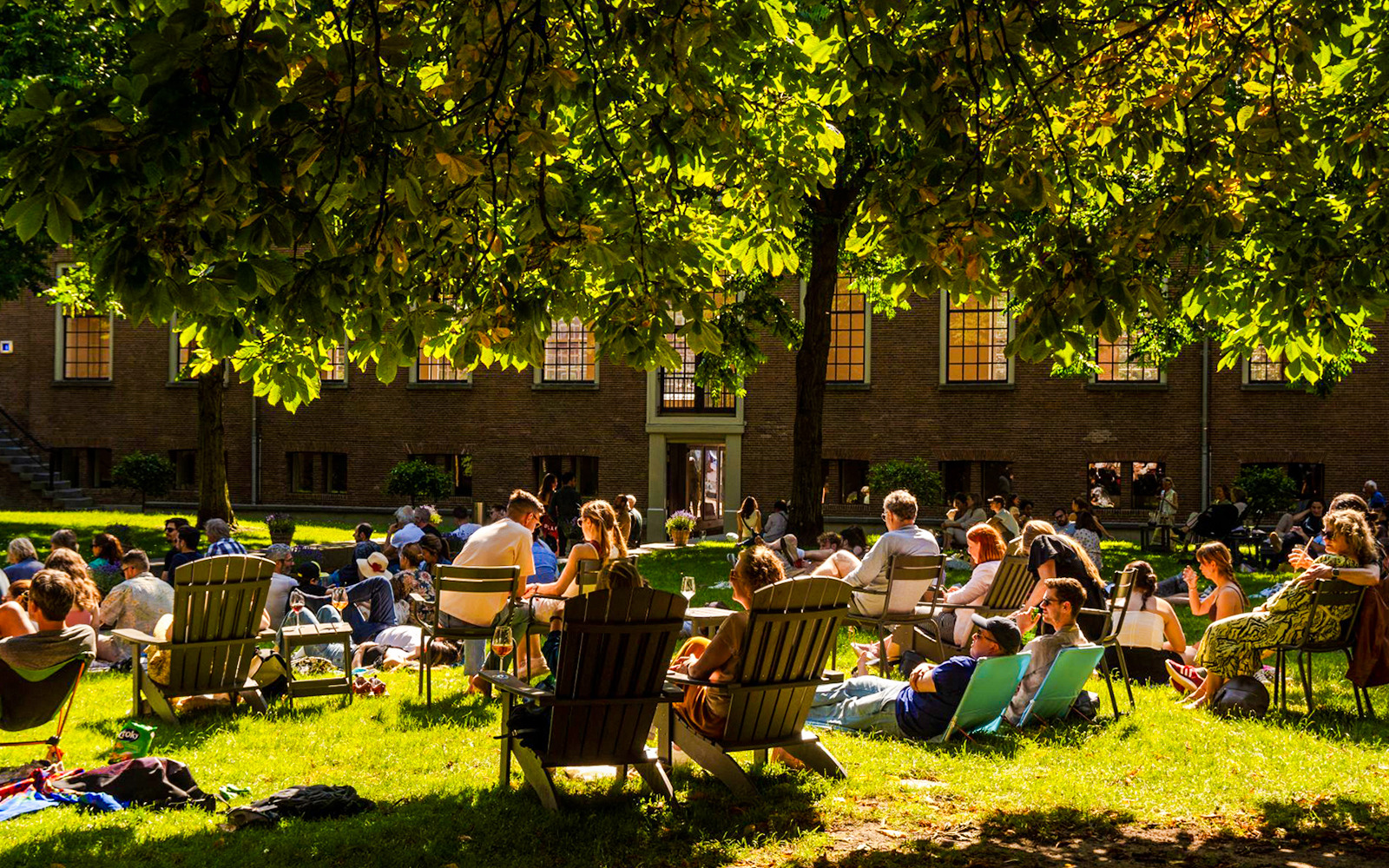 Visitors relaxing on the lawn outside the Hart Museum in Amsterdam.