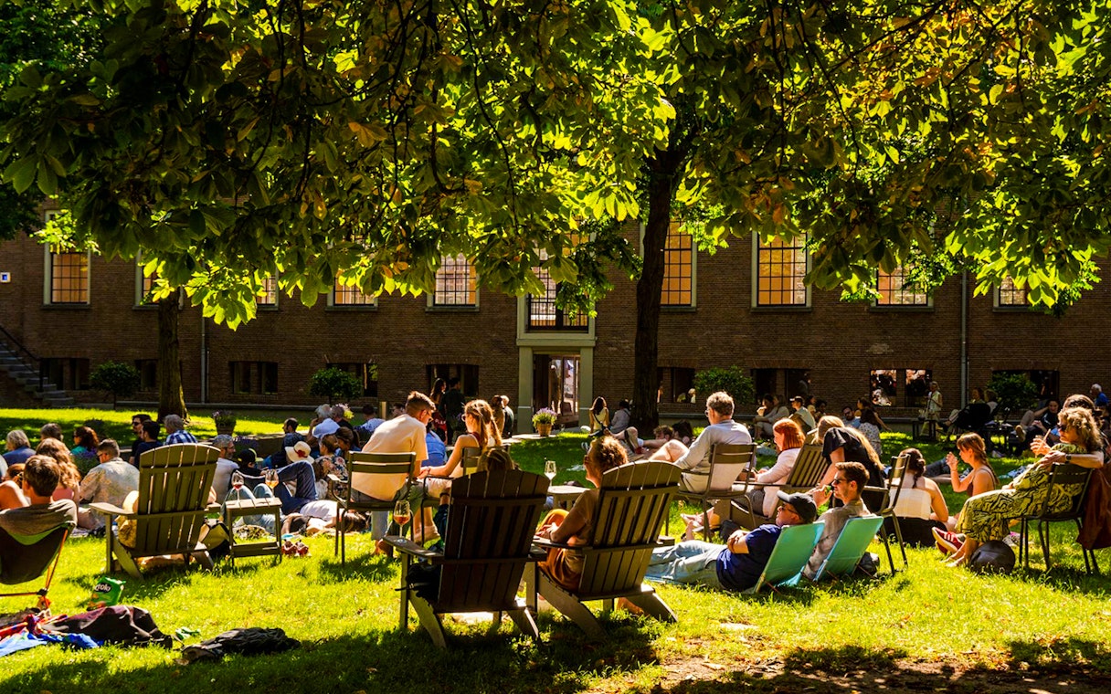 Visitors relaxing on the lawn outside the Hart Museum in Amsterdam.