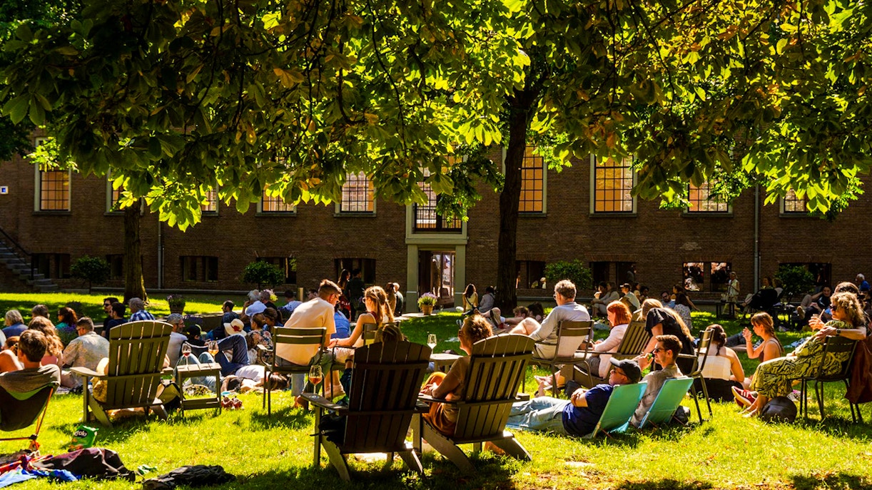 Visitors relaxing on the lawn outside the Hart Museum in Amsterdam.