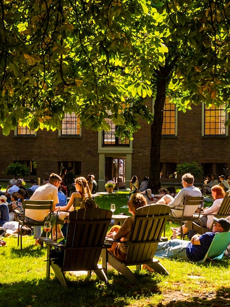 Visitors relaxing on the lawn outside the Hart Museum in Amsterdam.
