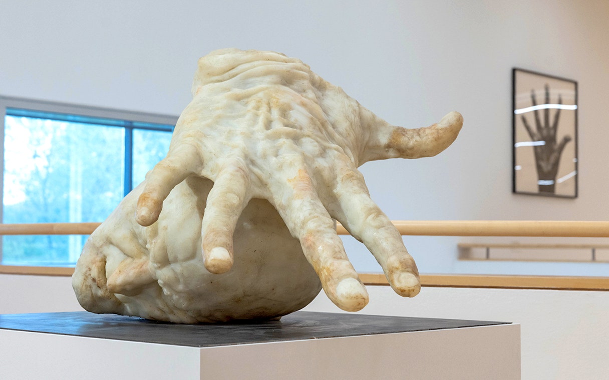Sculpture of a large hand inside ALBERTINA KLOSTERNEUBURG exhibit.