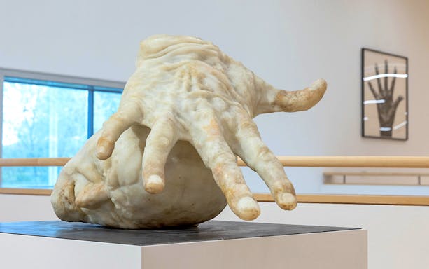 Sculpture of a large hand inside ALBERTINA KLOSTERNEUBURG exhibit.