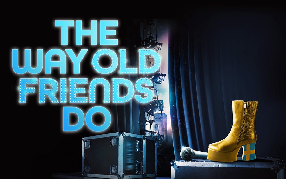 Stage setup with microphone, yellow platform boot, and "The Way Old Friends Do" text.