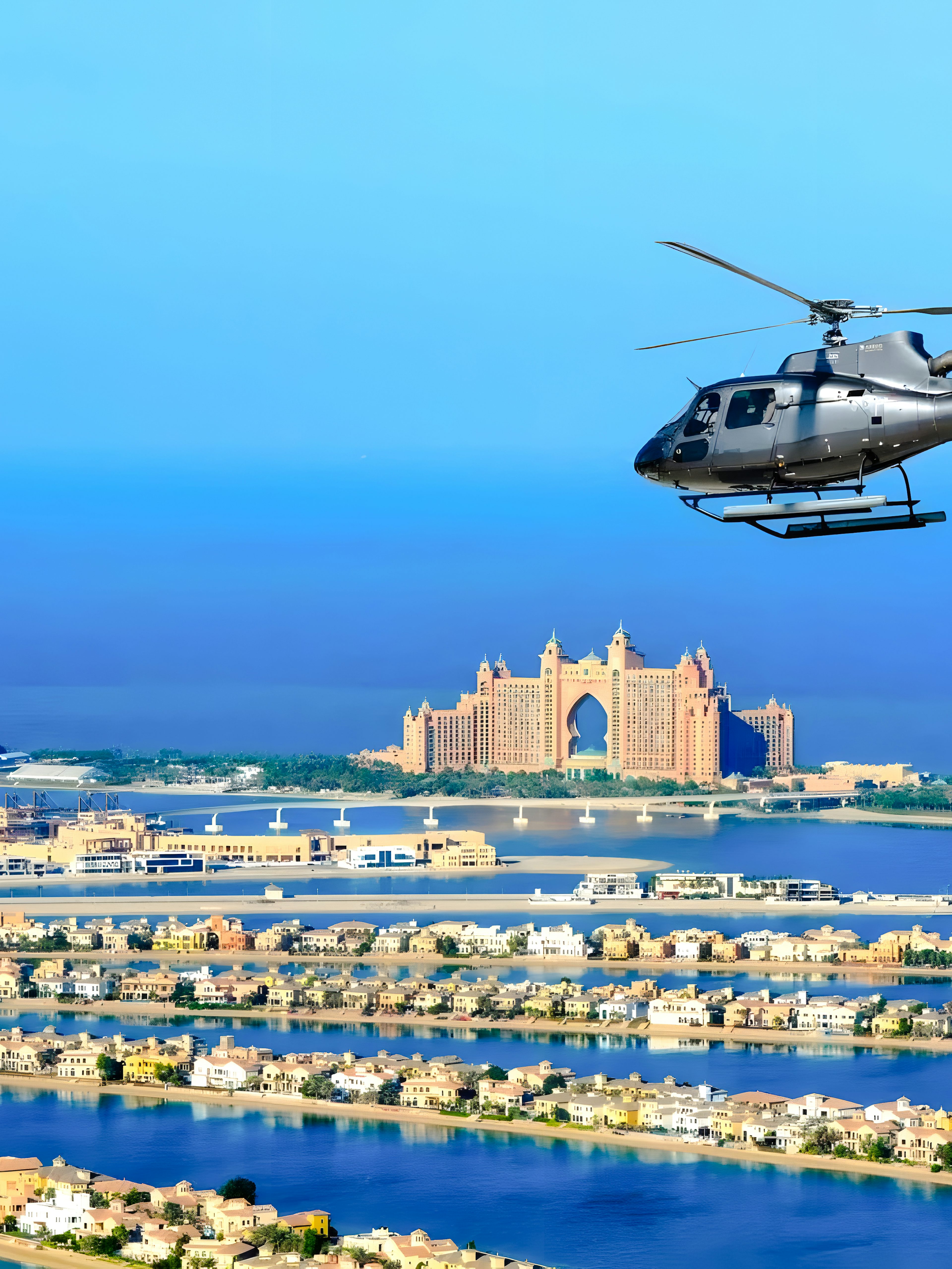Helicopter flying over Palm Jumeirah with Atlantis Hotel in Dubai.