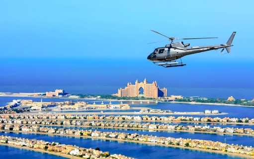 Helicopter flying over Palm Jumeirah with Atlantis Hotel in Dubai.