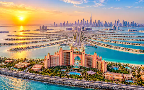 Dubai skyline with Palm Jumeirah and Atlantis hotel at sunset.
