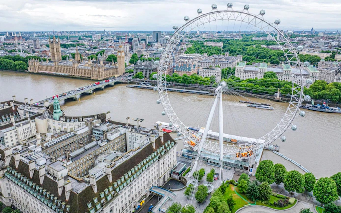 London Eye overlooking the Thames and Westminster in London cityscape.