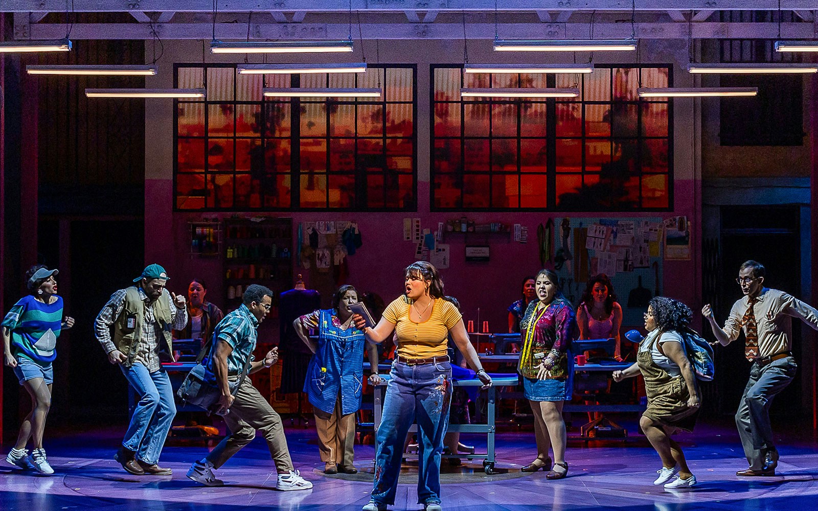 Cast performing a scene from "Real Women Have Curves: The Musical" on stage.