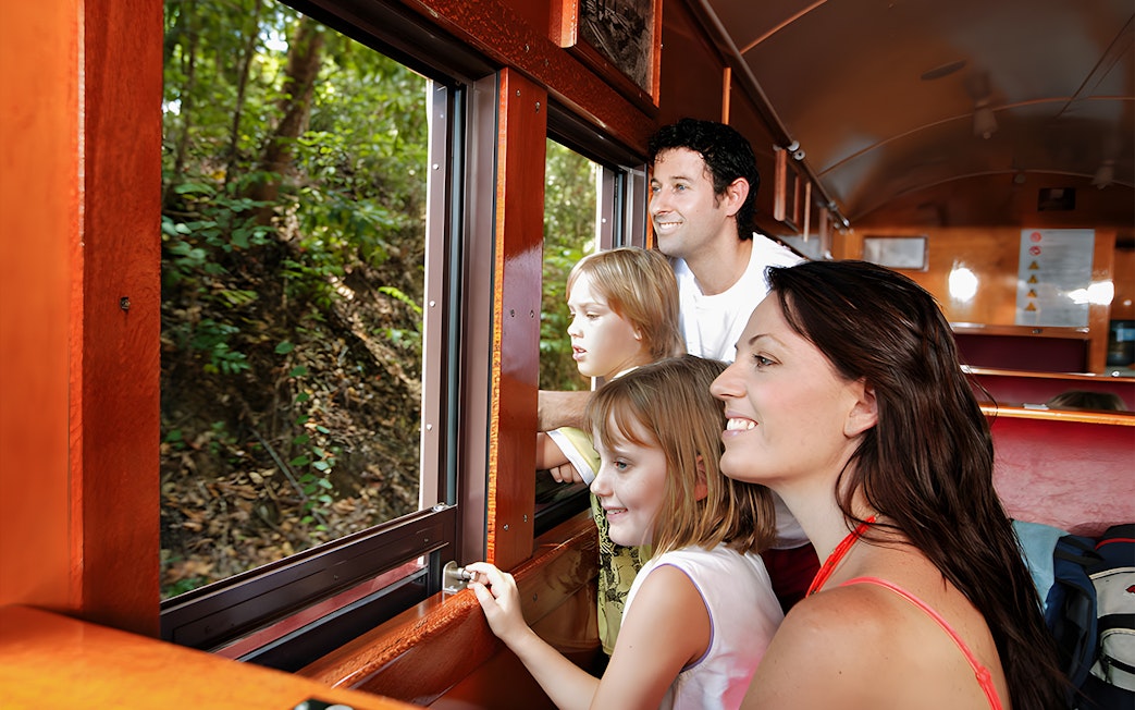 Family enjoying views from Kuranda Scenic Railway heritage train.