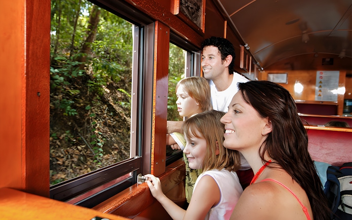 Family enjoying views from Kuranda Scenic Railway heritage train.