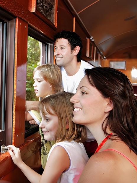 Family enjoying views from Kuranda Scenic Railway heritage train.