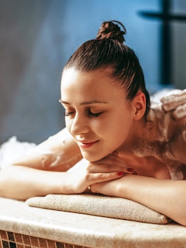 Woman relaxing during a spa treatment in a serene setting.