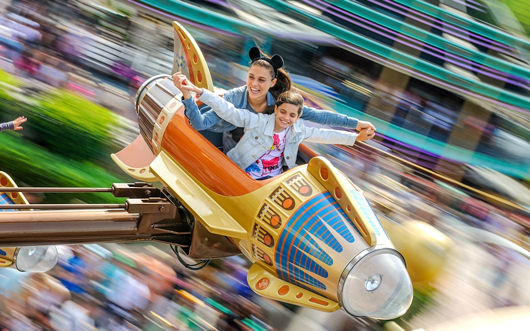 Visitors enjoying a ride at Disneyland Paris.