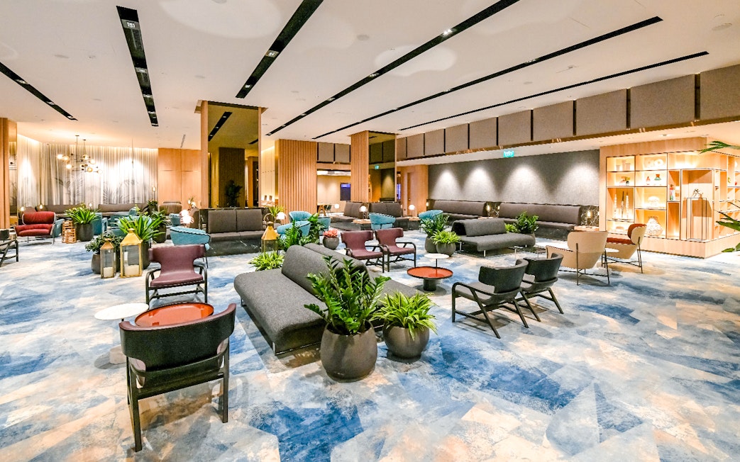 Changi Lounge interior with modern seating and plants, Singapore.