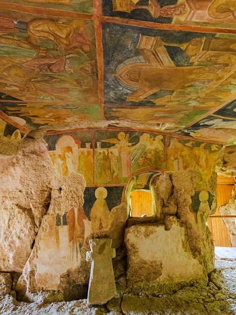 Frescoes inside the Rock Churches of Ivanovo, Bulgaria, depicting religious scenes on stone walls.
