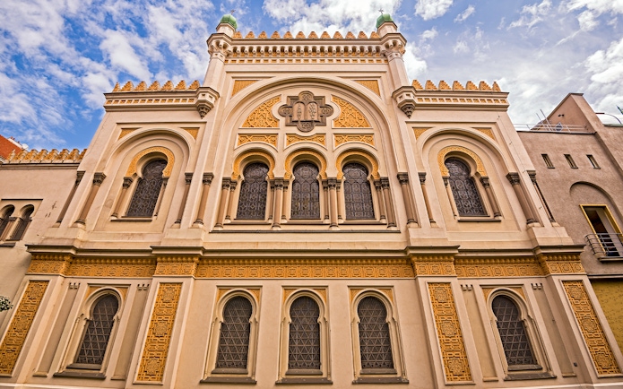 Spanish Synagogue facade in Prague, featuring ornate architectural details and arched windows.