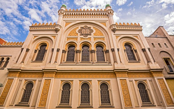 Spanish Synagogue facade in Prague, featuring ornate architectural details and arched windows.